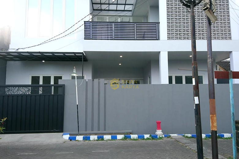Pagar belakang tinggi dengan elemen dekoratif yang menjaga privasi sambil memungkinkan cahaya alami masuk